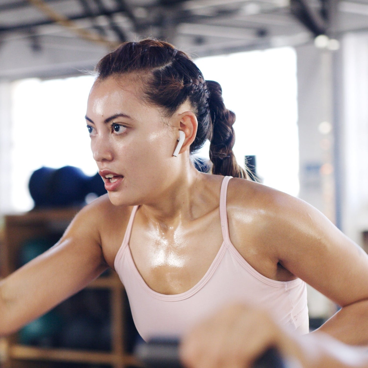 Woman exercising on a treadmill in a gym setting